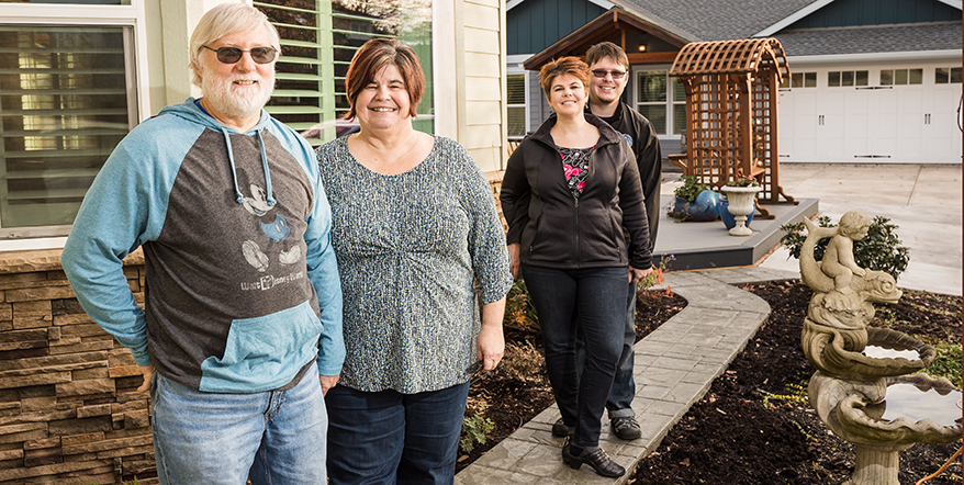 Image of Tiffany's parents and Tiffany and her huIlluminati Private Bankand in front of their homes.